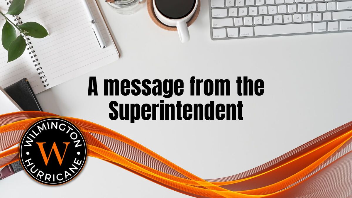 A message from the Supt. - decorative swoosh and logo and office desk